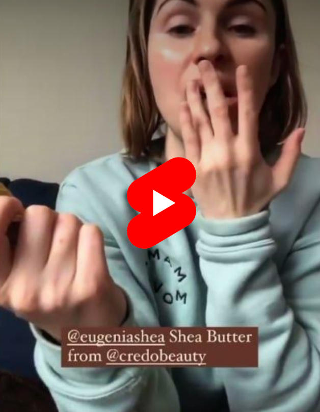 Woman applying shea butter to her lips 